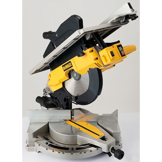 DEWALT D27113 combination mitre saw and table saw in yellow and black, shown in a studio setting with the blade and adjustable fence visible.