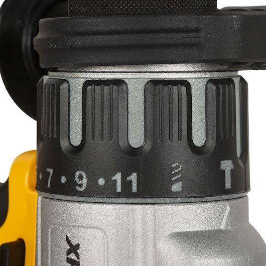 Close-up view of the torque adjustment ring and selector switch on a DEWALT cordless drill, showing numbers and symbols for different settings.