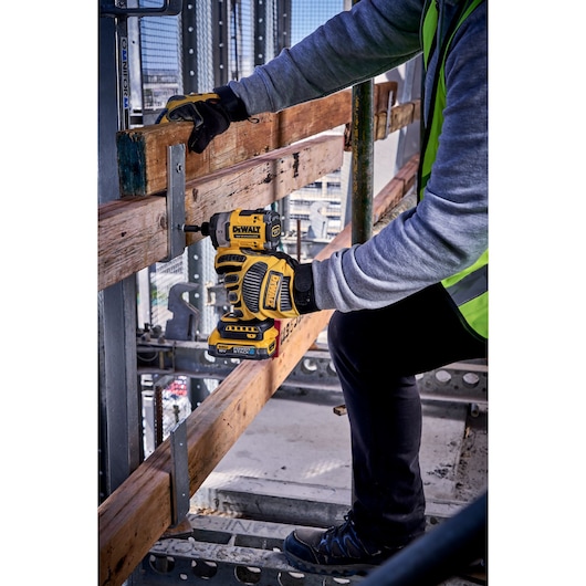 DEWALT DCF860N-XJ and DCF860N impact driver used on wood at construction site. Photography product category.