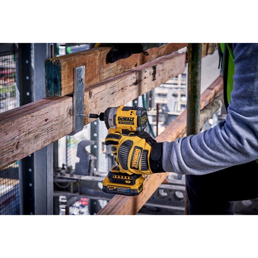 DEWALT DCF860N-XJ, DCF860N impact driver used on wood at construction site. Photography product category.