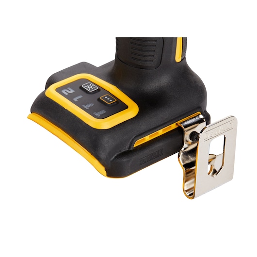 Close-up of the base of a DEWALT power tool showing control buttons and a metal belt clip attachment.