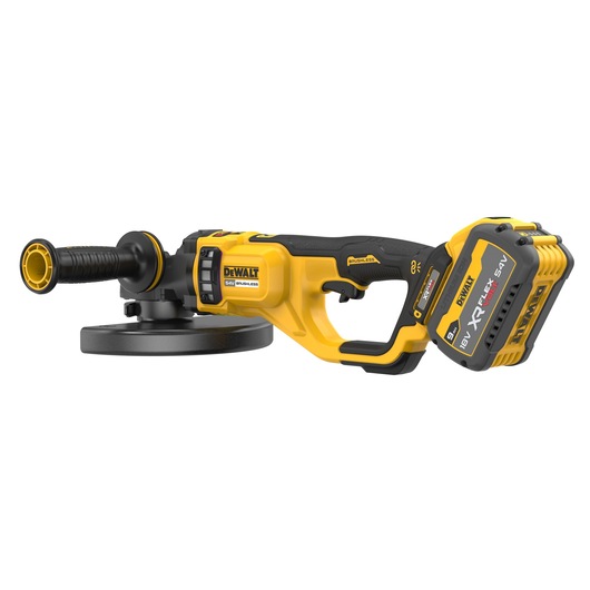 A DEWALT cordless angle grinder with a brushless motor and an 18V XR FLEXVOLT lithium battery pack. The tool is yellow and black, featuring a side handle and a flat grinding disc.