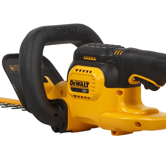 Close-up view of a DEWALT DCM563PB cordless hedge trimmer with an 18V battery, showing the yellow and black handle and body.