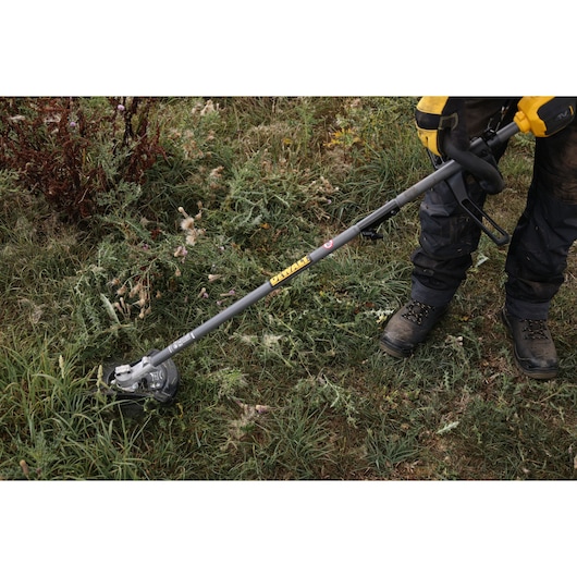 DEWALT garden tool in use. SKUs: DCMASED57X1, DCMASED9N, DCMASPH6N, DCMASPS5N, DCMASST1N, DCMASBC1N, DCMAS5713X1, DCMAS5713N.