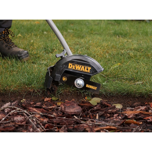 DEWALT grass edger in use. Photography category. SKUs: DCMASED9N, DCMASED9N-XE.