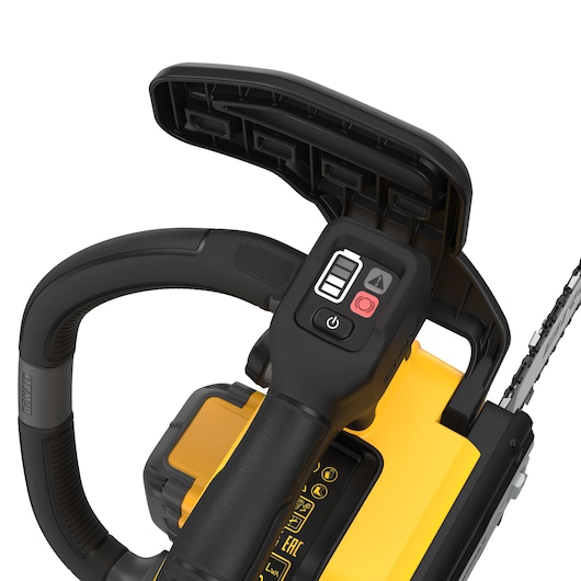 Close-up view of the handle and control buttons of a DEWALT cordless chainsaw, showing its safety guard, battery compartment, and part of the chain.