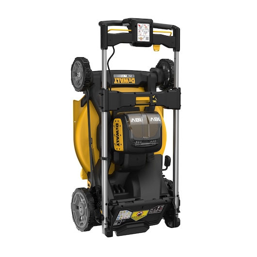 A DEWALT lawn mower in an upright storage position, showing its yellow and black body, wheels, and battery compartment.