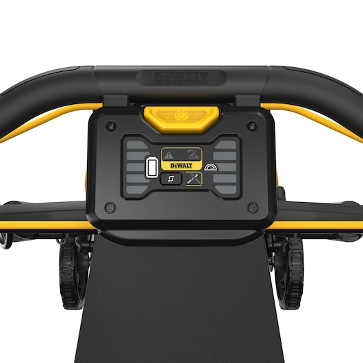 Close-up view of the control panel on a DEWALT lawn mower, featuring a yellow power button, various indicator icons, and handlebar with black and yellow details.
