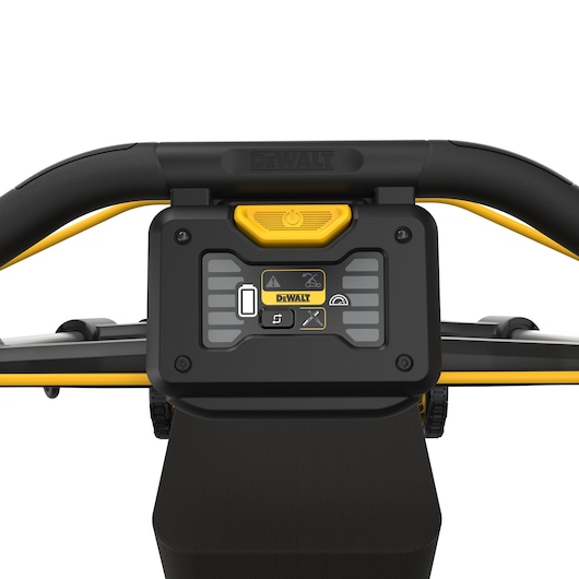 Close-up view of the control panel on a DEWALT lawn mower, showing various buttons, indicators, and a yellow power button, with the DEWALT brand name displayed.