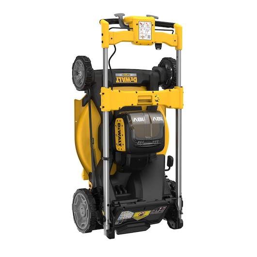 A DEWALT cordless lawn mower, shown in a vertical upright storage position. The mower features a yellow and black design, with two battery compartments and large wheels.