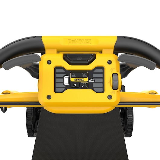 Close-up view of the control panel and handle of a DEWALT cordless lawn mower, showing various buttons and indicator icons. The handle is black and yellow, and the DEWALT logo is prominently displayed above the controls.