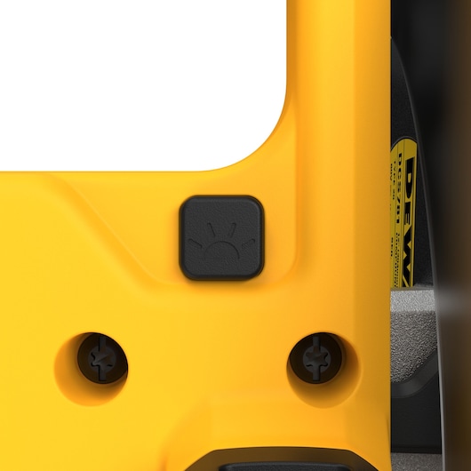Close-up view of a yellow DEWALT DCS781N tool, showing a black button with a light symbol, and two screw holes.