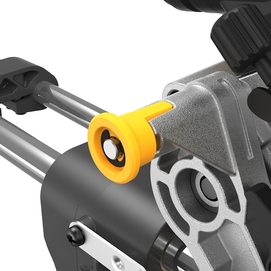 Close-up view of a DEWALT miter saw detail, showing the yellow and metallic adjustment knob and rail mechanism.