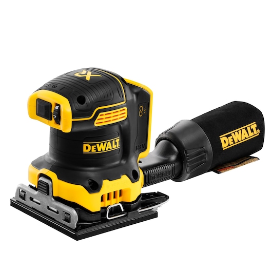 A DEWALT cordless 18V XR brushless finishing sander with a black and yellow design, shown with a detachable dust collection bag attached to the tool.