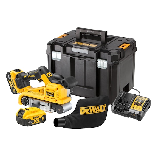 A DEWALT cordless belt sander kit, including a yellow and black belt sander, two 18V XR batteries, a battery charger, a dust bag with DEWALT branding, and a black storage case.