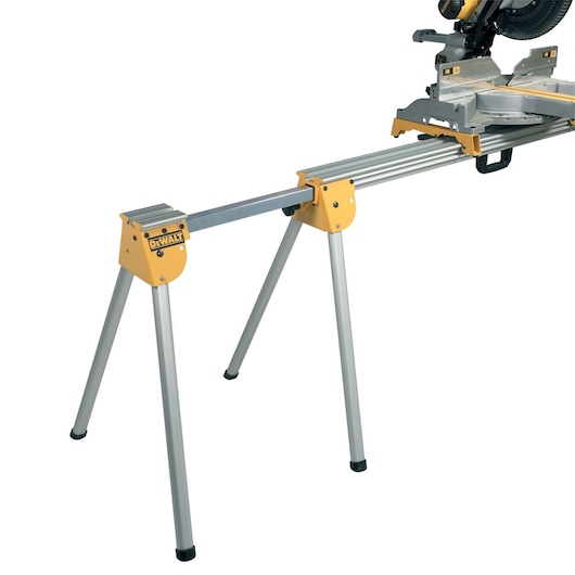 A DEWALT metal miter saw stand with foldable legs and a mounted miter saw, suitable for supporting workpieces during cutting.