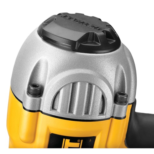 Close-up view of the top part of a DEWALT nail gun, showing the silver metallic and yellow housing with a black cap. The image highlights the tool's durable construction and the DEWALT branding on the cap.
