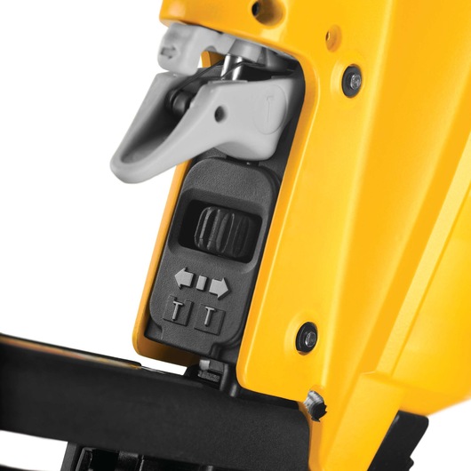 Close-up view of a DEWALT DPN1664 tool, showing a yellow and black housing with a detailed image of adjustment controls and a gray trigger mechanism.