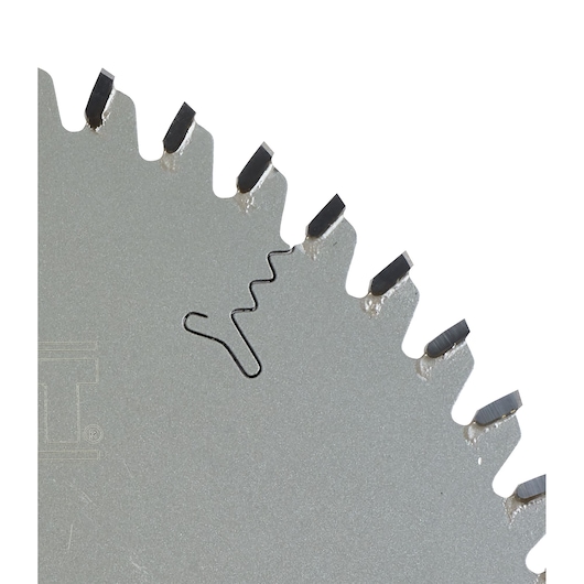 Close-up of a circular saw blade with sharp carbide teeth and a wavy expansion slot on the metal surface.