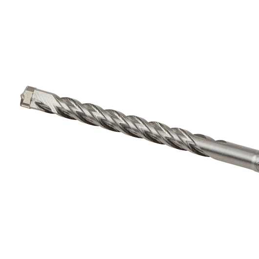 Close-up of a metal masonry drill bit with a spiral groove design and a carbide tip.