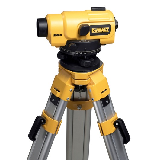 A yellow DEWALT optical level instrument mounted on a sturdy aluminum tripod, used for surveying and leveling, with adjustment knobs and measurement markings visible.