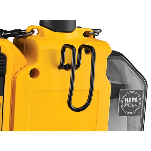 Close-up view of a yellow DEWALT device featuring a black metal hook and a transparent section with a visible HEPA filter label.