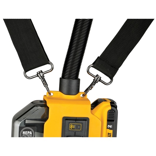Close-up of a DEWALT portable device with a HEPA filter, featuring a yellow and black body, a flexible black hose, and two black straps attached with metal clips.
