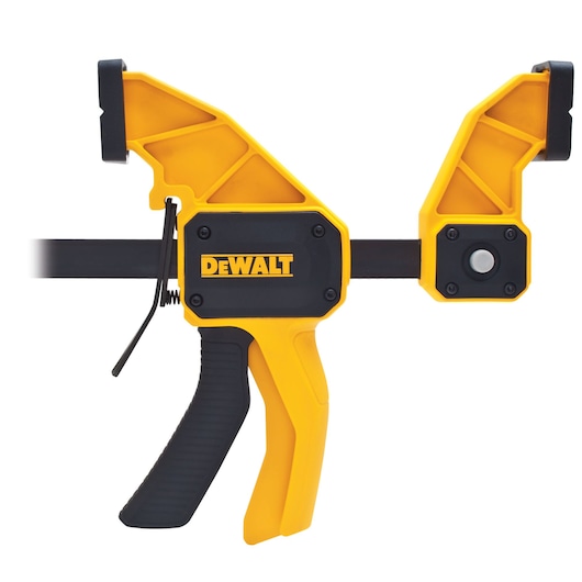 A DEWALT branded yellow and black trigger clamp, used for securing materials during woodworking or construction tasks.