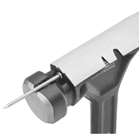 Close-up of a DEWALT hammer head with a nail holder feature, showing the nail held securely in place on the hammer head.