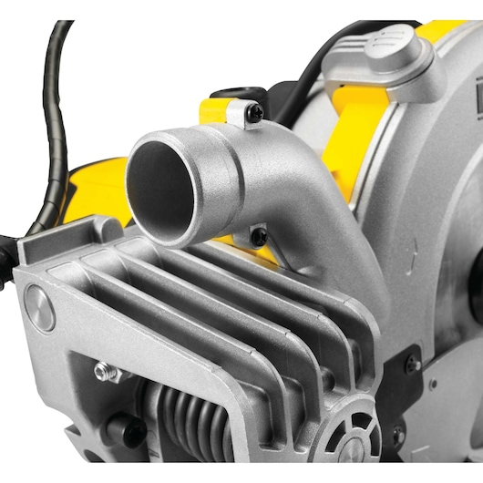 Close-up view of a DEWALT DWS778 miter saw, focusing on the metal dust extraction port and part of the saw's motor housing.