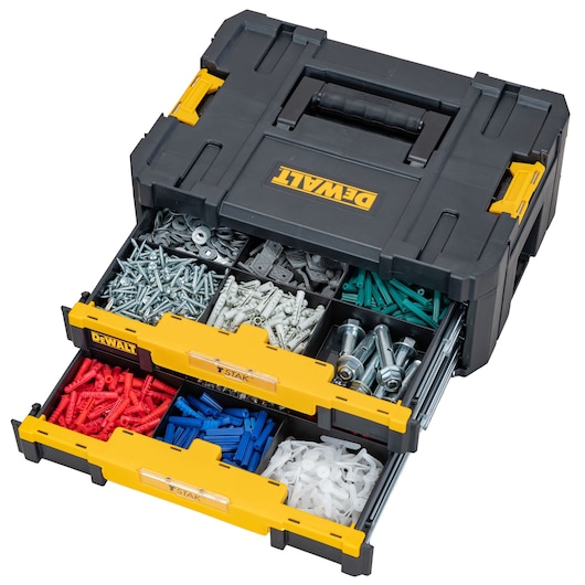 A DEWALT portable organizer box with two drawers, each divided into compartments filled with various hardware items such as screws, bolts, washers, and colored plastic wall plugs.