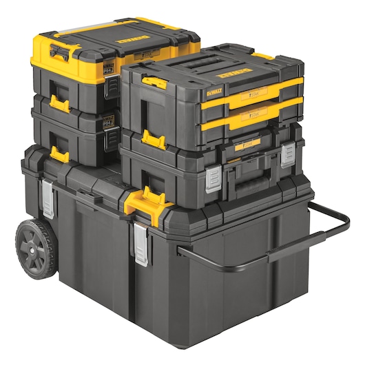 A stack of DEWALT black and yellow tool storage boxes, including multiple interlocking cases and a large wheeled box with a metal handle for easy transportation.