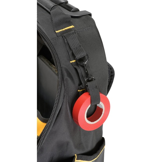 Close-up of a black DEWALT tool bag with a roll of red tape attached to a strap with a clip.