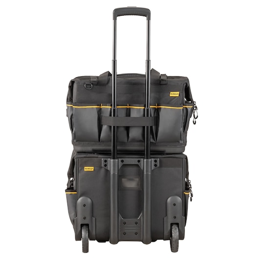 A DEWALT rolling toolbox bag with a telescopic handle, black color, multiple pockets on top, and wheels for easy transport. The bag is designed for carrying tools and equipment.