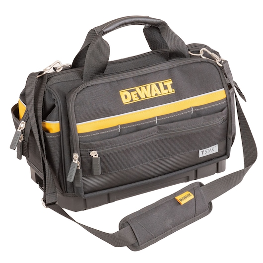 A black and yellow DEWALT branded tool bag with multiple zippered compartments, a shoulder strap, handles, and the TSTAK label. The bag is made of durable fabric and is designed for carrying tools.