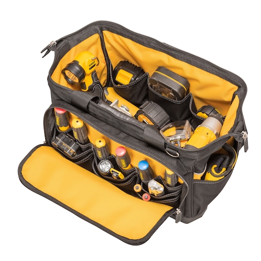 A black and yellow DEWALT tool bag with multiple compartments, filled with various hand tools and accessories, including screwdrivers, batteries, a flashlight, and other equipment.