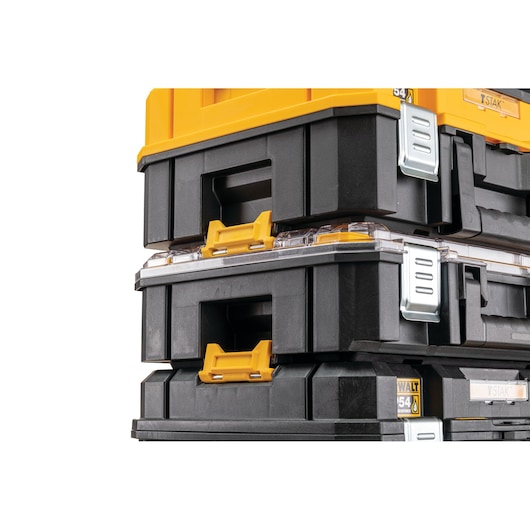 Close-up view of stacked DEWALT black and yellow storage tool boxes with metal latches.