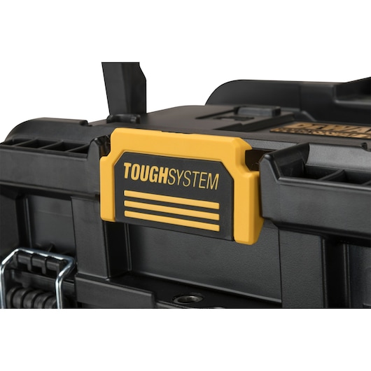 Close-up of a DEWALT ToughSystem storage box, showing the yellow and black latch and sturdy construction.