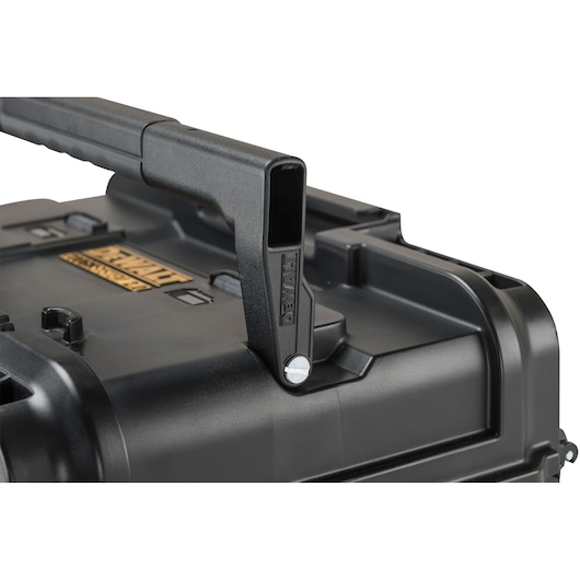 Close-up view of a DEWALT black tool case showing the sturdy plastic handle and part of the surface with branding.