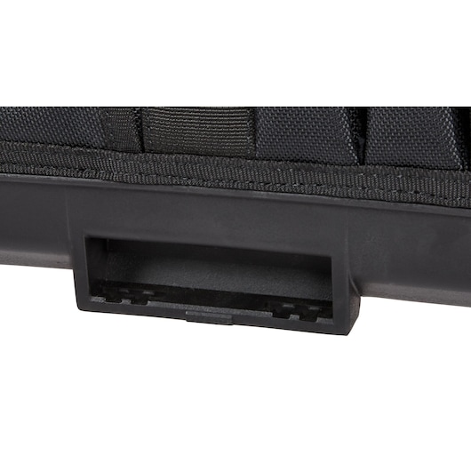 Close-up view of a black rectangular plastic compartment or slot attached to a fabric surface, likely part of a tool storage product.
