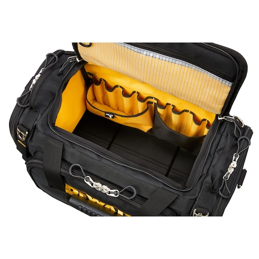 Open view of a DEWALT black and yellow tool bag showing multiple interior pockets and compartments for organized storage.