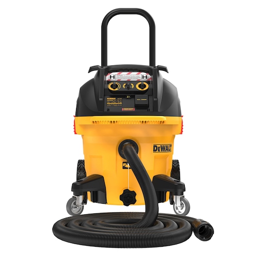 A DEWALT DWV905H industrial vacuum cleaner with a yellow base, black upper section, large wheels, a carry handle, and a flexible hose coiled in front. The vacuum is designed for heavy-duty cleaning tasks.