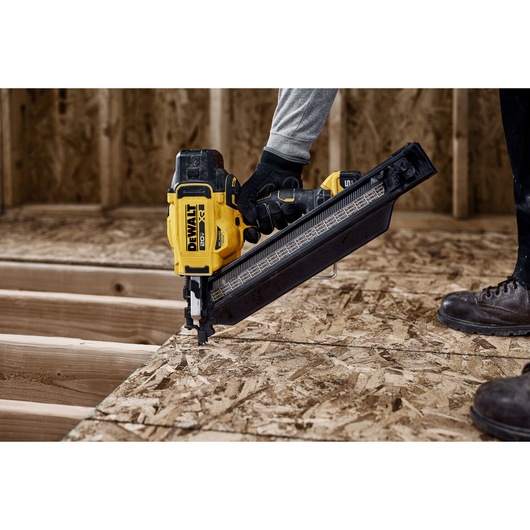 DEWALT nailer in use on wood, model DZN930-XJ, DZN930. Photography product. Construction scene.