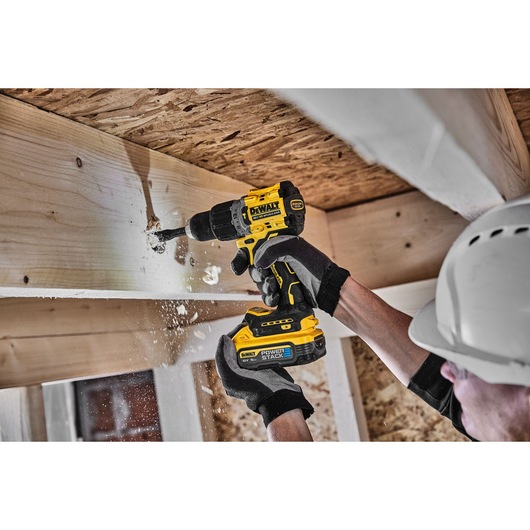 18V XR Brushless Hammer Drill Driver right side view with LED light drilling wooden beam