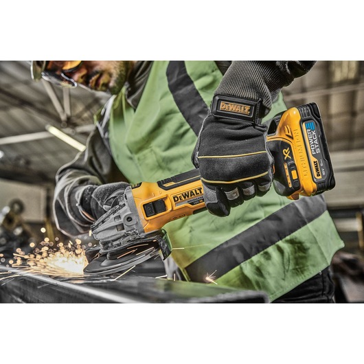 18V XR Brushless 125mm Grinder right side close up with spinning disc in factory