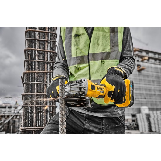 18V XR Brushless 125mm Grinder 3/4 right side grinding metal on work site