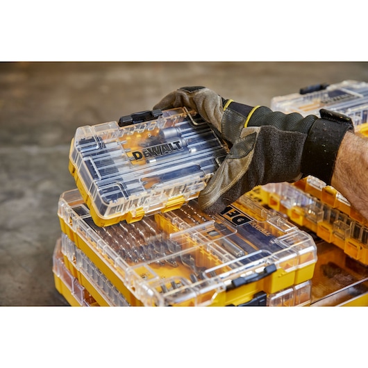 overhead front shot of user holding DEWALT 40 Piece Impact Screwdriver Bit Set with closed case lid and out the pack