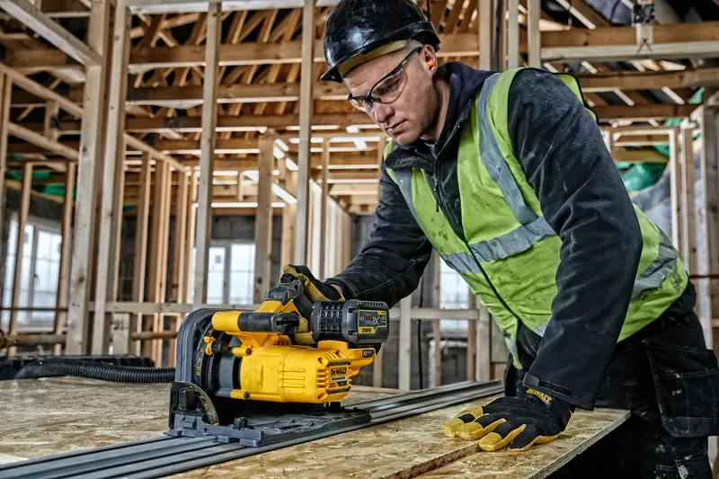 Photo of DEWALT track saw DCS520T2-QW, DCS520T2-XE, DCS520T2 in use on wood at construction site.