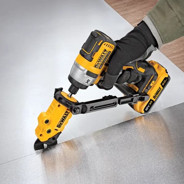 DEWALT power tool with attachment cutting sheet metal, operated by a gloved hand.