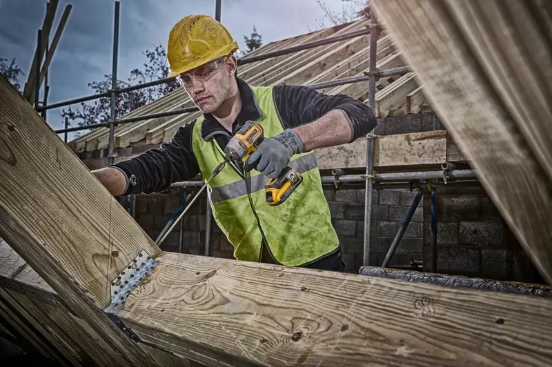 DEWALT DCF887NT, DCF887NT-XJ, DCF887N-XJ impact driver in use on wood by worker wearing helmet and vest at construction site.